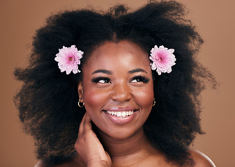 Image showing Afro hair, thinking or happy black woman with flowers, beauty or smile on a brown studio background. Hairstyle, floral or natural African female model with shine or growth ideas with wellness or glow