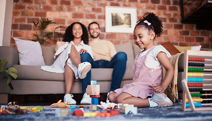 Image showing Happy, playing and a child with building blocks and parents for relax, education and learning in a house. Smile, playful and a girl kid with toys and a mother and father in a living room as family