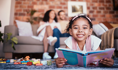 Image showing Home, portrait and girl on the floor, reading book and happiness with knowledge, relax and weekend break. Face, kid and female child in a lounge, parents and story with fun, playful and learning