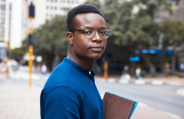 Image showing Portrait, serious student and black man in city outdoor to travel to university school. Face, glasses and African learner or college person in Kenya in urban street with book in education or studying