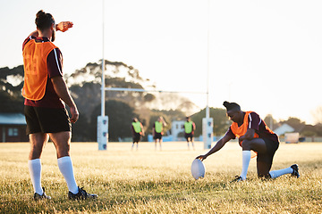 Image showing Rugby, sun and sport game with support, exercise and competition with athlete ball training. Field, back and target practice on grass with cardio, fitness and team workout outdoor for teamwork