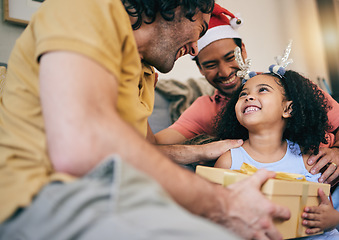 Image showing Gay father, child and Christmas gift with present, house or celebration on festive holiday with smile, love or care. LGBTQ men, parents and girl kid with box, xmas fashion or culture in family home