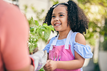 Image showing Gardening, parent and girl child with plants in backyard, teaching and learning with growth in nature. Smile, sustainability and person helping daughter in vegetable garden with love, support and fun