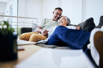 Image showing Smile, home and senior couple on couch, love and retirement with marriage, laughing and relax. Old man, funny and mature woman on a sofa, conversation and romance with discussion, care and happiness