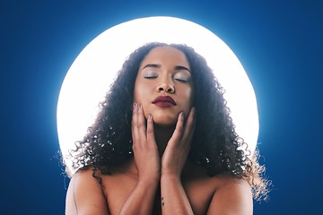 Image showing Makeup, spotlight and face of woman with beauty for wellness, cosmetics and facial in studio. Neon circle, creative salon and person for skincare, glamour or aesthetic on blue background for art deco