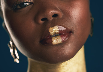 Image showing Portrait, beauty and black woman in gold for culture, heritage or tradition on a blue background in studio. Face, skincare and african style with a young model closeup for elegance or cosmetics