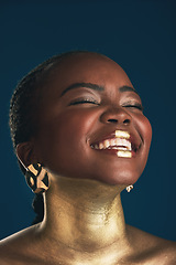 Image showing Gold makeup, face and black woman laughing at funny creativity, facial cosmetics paint and beauty art design. African culture joke, comedy or glamour person with creative face glow on blue background