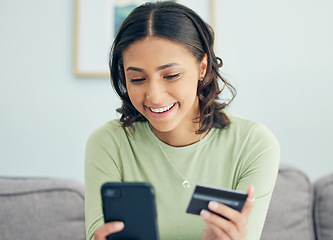 Image showing Credit card, phone and woman on a sofa happy for cashback, savings or ecommerce sale in her home. Smartphone, and female customer in a living room smile for sign up, survey or bank, payment or budget