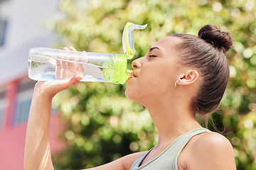 Image showing Woman, fitness and drinking water in nature for sustainability after workout, training or outdoor exercise. Thirsty female person with bottle for natural nutrition, mineral or liquid diet in the park