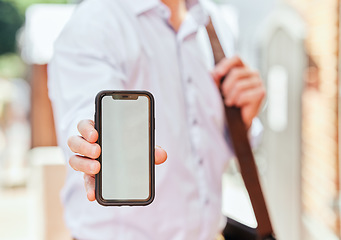 Image showing Hand, phone and mockup with a business man in the city on his morning commute into work closeup. Mobile, app or communication with an employee showing blank space on a screen or display outdoor