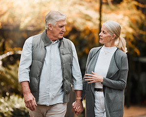Image showing Love, park or couple holding hands, walking and enjoy time together, relax conversation and nature. Wellness, marriage and elderly people on romantic date, outdoor freedom or talking about retirement