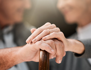 Image showing Holding hands, couple and a cane in nature for love, bonding and support. Peace, closeup and a senior man and woman in a park with a walking stick, care and together in a garden with trust on a date