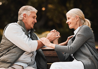 Image showing Love, park bench and senior happy couple holding hands, bond and enjoy time together, freedom and connect in garden. Eye contact, trust and support of old man, woman or marriage people on nature date