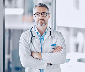 Image showing Mature doctor man, arms crossed and portrait for leadership in hospital, medical research or serious face for wellness. Professional medic, healthcare expert and clinic management job in Los Angeles