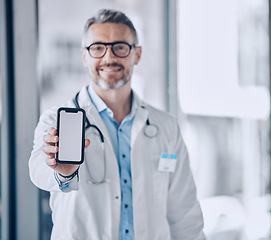 Image showing Doctor, phone screen and mockup for healthcare presentation, communication or FAQ in hospital. Medical portrait of man with mobile app, advertising or ux design space for contact us or clinic sign up