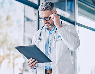 Image showing Mature doctor man, reading tablet and thinking with report, medical information or paperwork for insurance. Medic, healthcare expert and digital touchscreen for data analysis, research and results