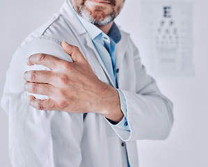 Image showing Doctor man, shoulder pain and hand with stress injury, fatigue and burnout at optometry job in clinic. Ophthalmologist, emergency or accident with muscle, bone or joint with massage in hospital