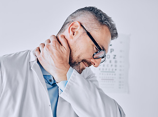 Image showing Healthcare, neck pain or optometry and a doctor in his office with an injury while feeling stress. Medical, burnout or accident with a mature optician holding his spine or shoulder in a clinic