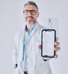 Image showing Phone, screen and optometrist in eye exam, test or booking an assessment for vision with mobile app, internet or website. Cellphone, mockup and doctor testing eyesight in office with technology