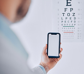 Image showing Phone, screen and hand of person in eye exam, test or booking assessment for vision with mobile app or internet. Cellphone, mockup and optometrist doctor testing eyesight in office with technology