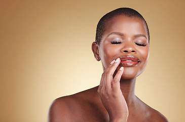 Image showing Makeup, beauty and a black woman with hands on mouth in studio for skin care, glow and cosmetics. Face of african model person with shine on lips, dermatology and mockup space on beige background