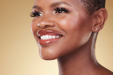 Image showing Beauty, makeup and face of a happy black woman in studio for self care, skincare and cosmetics. Closeup of African aesthetic model person with facial shine, teeth smile and glow on a beige background