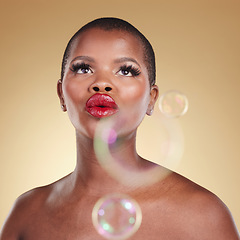 Image showing Luxury, makeup and bubbles with face of black woman in studio for cosmetics, spa treatment and beauty. Skincare, dermatology and self care with model on gold background for glow, facial and soap