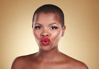 Image showing Black woman, lips and kiss, red lipstick and beauty with makeup and portrait isolated on studio background. Pout, cosmetics product on mouth and bold color with headshot, shine and cosmetology