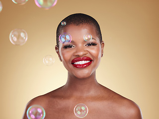 Image showing Smile, makeup and bubbles with portrait of black woman in studio for cosmetics, spa treatment and luxury. Skincare, dermatology and self care with model on gold background for glow, facial and beauty