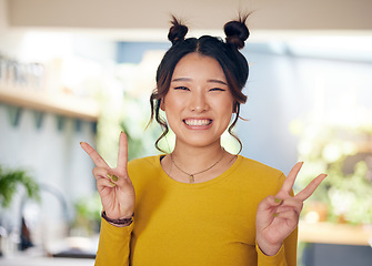 Image showing Peace, hands and portrait of Asian woman in home with happiness, v sign or gen z person in kitchen, living room or apartment. Happy, girl and unique fashion in house with confidence and smile on face