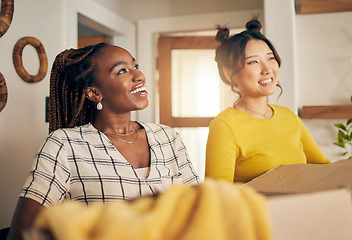 Image showing Happy, smile and lesbian couple moving in their new home with cardboard boxes together in living room. Happiness, love and interracial lgbtq women homeowners in the lounge of their modern apartment.