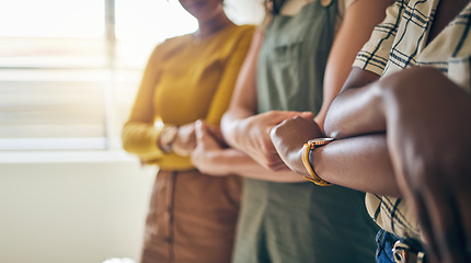 Image showing Holding hands, arms crossed and unity with business women in a row for equality or empowerment. Support, teamwork or collaboration with a creative employee group in the office for partnership closeup