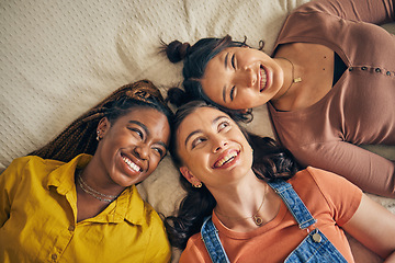 Image showing Group of women, friends on bed with smile and bonding in living room together from above. Happiness, care and friendship, girls relax in bedroom with diversity, pride and people in home with fun.