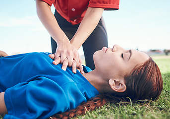 Image showing Cpr, outdoor and hands on chest, women and help on a field, resuscitation and medical emergency. Closeup, player outside and heart attack with volunteer, accident and first aid to rescue a person