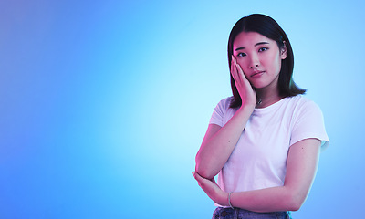 Image showing Mockup, neon and portrait of Asian woman in studio for information, promotion and deal on blue background. Creative lighting, marketing and isolated person with space for news, announcement and sale