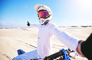 Image showing Selfie, motorcycle and man in desert adventure, nature and sports outdoor on mockup space. Bike, helmet and person take picture at sand for social media, transportation and off road travel in Morocco