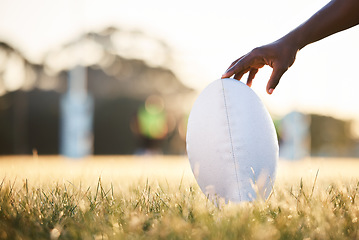 Image showing Sports, rugby and hand of person with ball ready for game, competition and tournament outdoors. Fitness, mockup and closeup of player on grass field for exercise, training and workout in practice