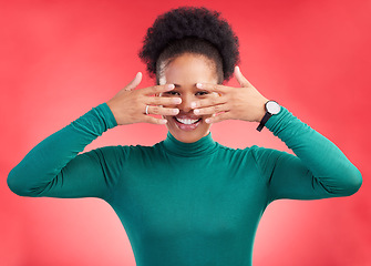 Image showing Hands, cover face and woman in studio with hiding and eyes peak with a smile. African female person, red background and happy with secret and model from Chicago with gossip announcement and portrait