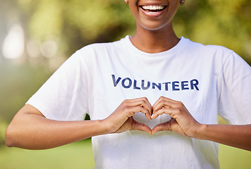 Image showing Heart, hands and volunteer smile with sign for care, support and charity outdoor in nature, forest or environment. Show, love and happy person volunteering in community or service with empathy