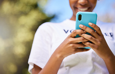 Image showing Black woman, phone and hands typing in nature for communication, social media or outdoor networking. Closeup of happy African female person smile in chatting or texting on mobile smartphone app