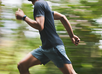 Image showing Man, motion blur and running in park for exercise, fitness action and power of cardio workout. Closeup, runner and sports athlete training for marathon with energy, speed and fast performance outdoor