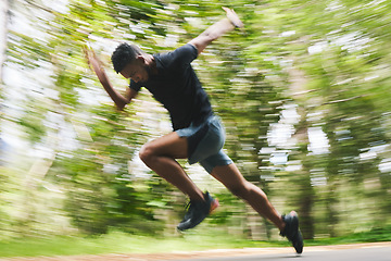 Image showing Running, fitness and blur of man in forest for marathon training, exercise and cardio workout. Sports, race and athlete with speed for wellness, performance and endurance for challenge in nature