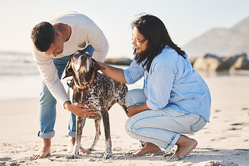 Image showing Beach, love and couple with dog by ocean for freedom, adventure and bonding together in nature. Happy pet, petting canine and man and woman by sea for exercise, wellness and training outdoors