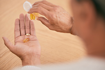 Image showing Person, hands and pills in medication, illness or omega tablets for joint or muscle pain on desk at home. Closeup of patient taking drugs or capsules in container for healthcare, antibiotics or cure