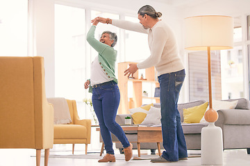 Image showing Happy, mature couple and dancing at home for anniversary, birthday or valentines celebration. Laugh, love and care of man and woman for healthy marriage, happiness and moving or spin with a smile