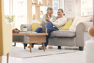 Image showing Happy elderly couple, phone and relax on sofa in living room for social media or entertainment at home. Mature man and woman smile on mobile smartphone app together in happiness on couch in house