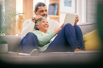 Image showing Mature couple, relax and happy on sofa with tablet for streaming a funny, comedy show or movie together in lounge. Reading, man and woman in retirement with social media or app for communication