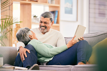 Image showing Happy, mature couple and relax on sofa with tablet for streaming a funny, comedy show or movie together in lounge. Love, man and woman in retirement with social media or mobile app for communication