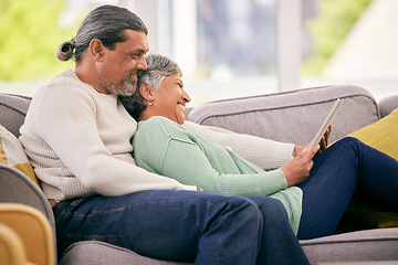 Image showing Tablet, mature couple and relax on sofa for streaming a funny, comedy show, movie or video together in lounge. Happy, man and woman in retirement with social media or mobile app for communication