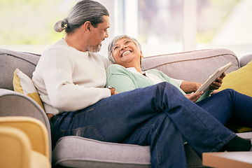 Image showing Happy, mature couple and tablet on sofa to relax with streaming a funny, comedy show or movie together in lounge. Love, man and woman in retirement laughing with mobile app or conversation in home